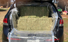 Load image into Gallery viewer, The Logan Liner with 4 bales of hay loaded in a medium size SUV